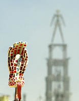 Burning man in the background of love hand art sculpture made of mosaic