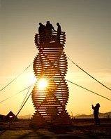 Sunrise silhouettes of double helix wooden art installation