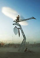 People climbing the crane art sculpture