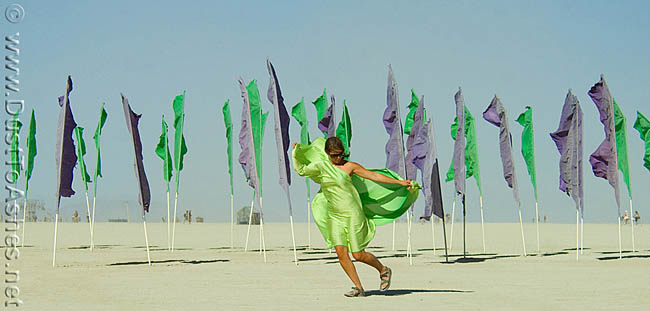 Woman dancing with light flying green silk