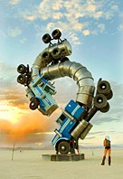 Burning Man Big Rig Jig sunset and girl looking at giant art installation surreal sculpture