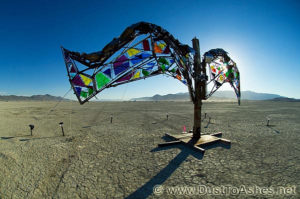 Burning Man glass art sculpture in the form of spread wings