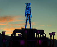 Neon silhouette of Burning Man edifice