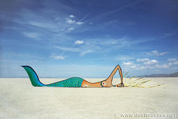 Surreal mermaid in black rock city desert