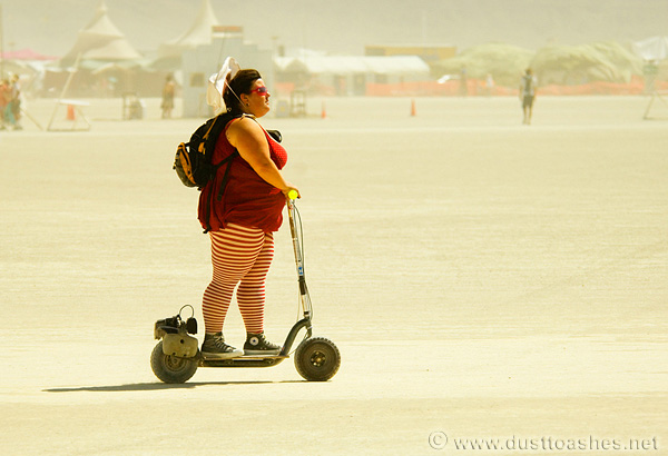 Riding scooter on playa