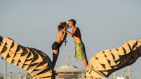 Kissing young couple in front of the the Burning Man 2013