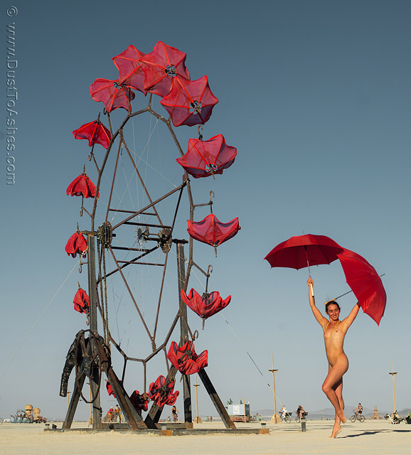 Nude dancing girl with red umbrellas