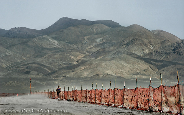 Woman Running along the trash fence perimeter of Burning Man
