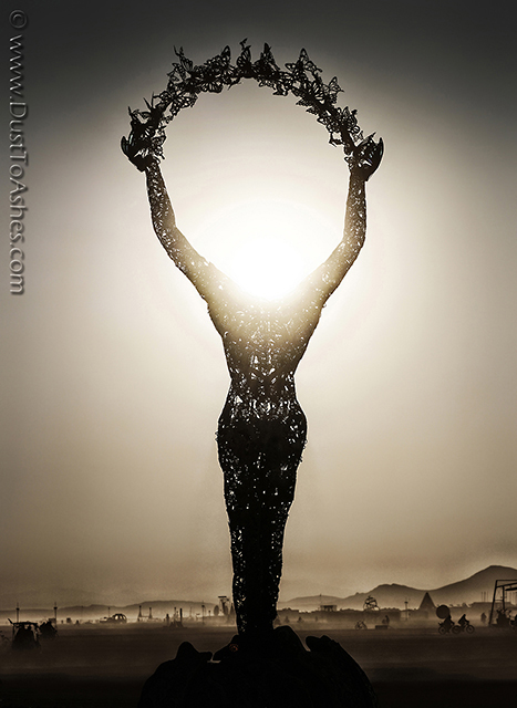 Sunrise silhouette of the headless female statue made by Dana Albany.