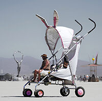 Man sitting in a giant stroller