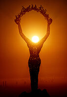 Statue of a woman releasing the butterflies during sunrise